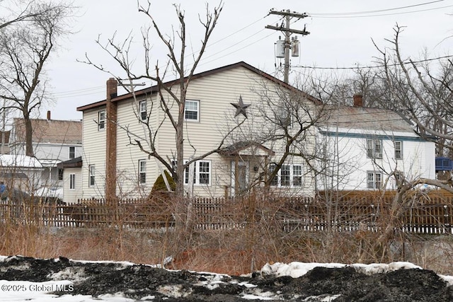 view of front of property featuring fence and a chimney