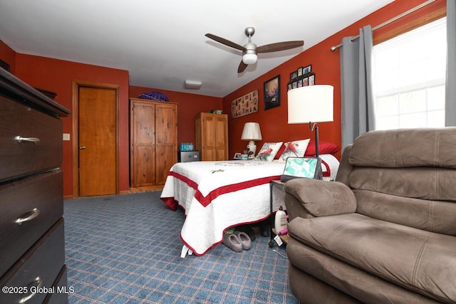 bedroom featuring ceiling fan and carpet floors