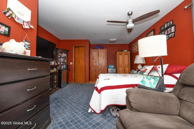 bedroom featuring ceiling fan and dark colored carpet