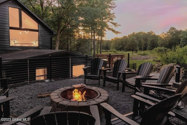 724 Green Lake Rd, Athens, NY 12015 - patio terrace at dusk with an outdoor fire pit and a wooden deck