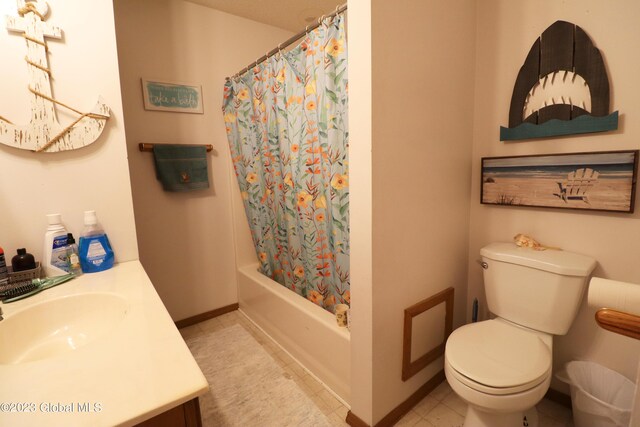 bathroom with shower / bath combination with curtain, toilet, vanity, baseboards, and tile patterned floors