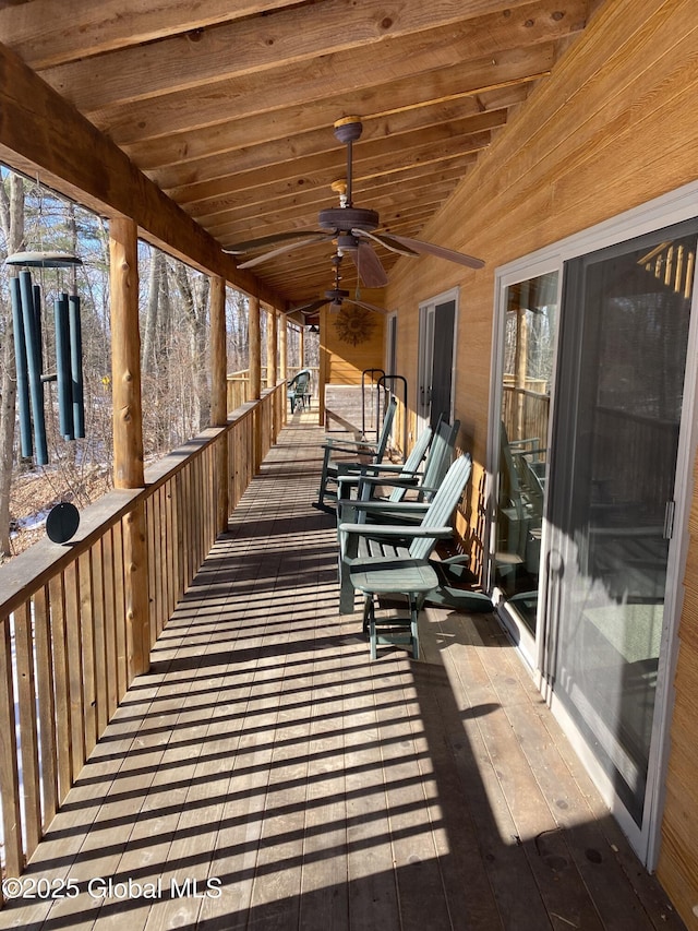 wooden terrace featuring a ceiling fan