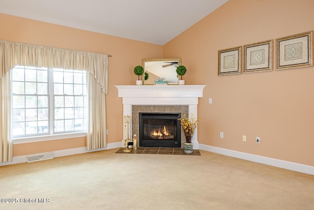 unfurnished living room with vaulted ceiling, visible vents, carpet floors, and a tile fireplace