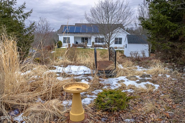 view of front of house featuring roof mounted solar panels