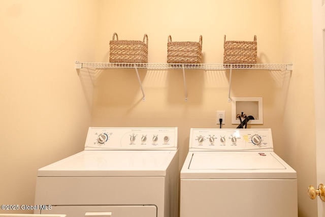 clothes washing area with laundry area and washer and clothes dryer