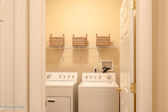 laundry area featuring washing machine and clothes dryer and laundry area