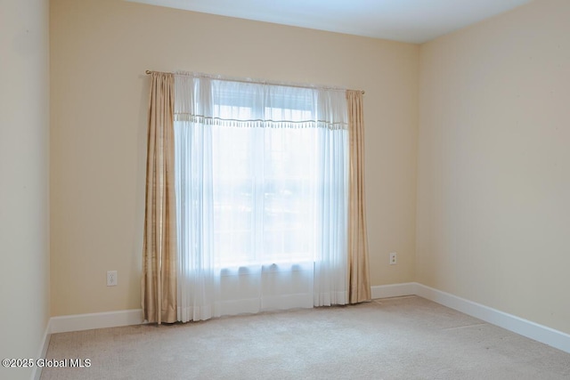 carpeted spare room with baseboards