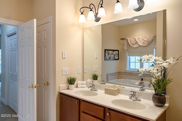 bathroom with double vanity, a tub, and a sink