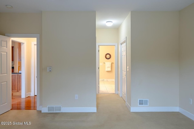 interior space with visible vents, baseboards, and carpet flooring