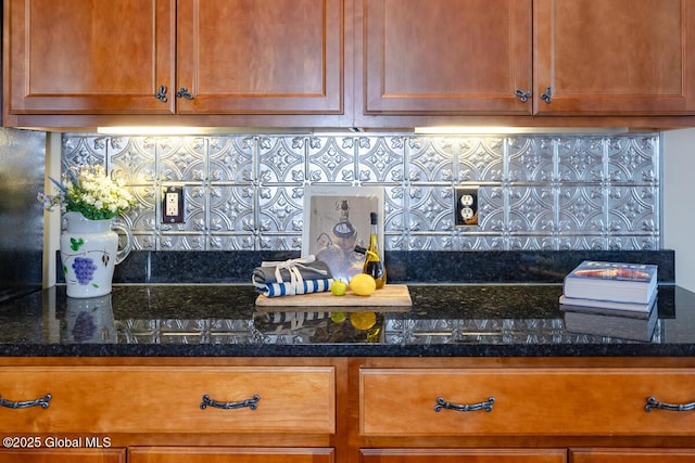 interior space featuring brown cabinetry, backsplash, and dark stone countertops