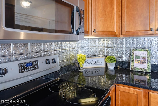 kitchen with decorative backsplash, brown cabinets, and stainless steel appliances