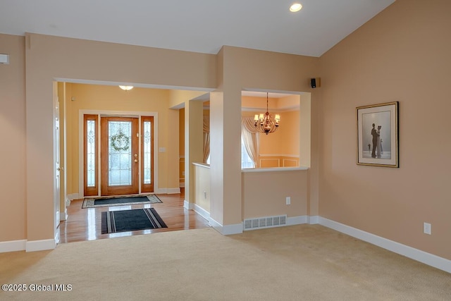 carpeted entryway with recessed lighting, a notable chandelier, baseboards, and visible vents