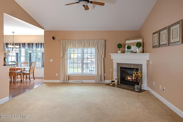 unfurnished living room with visible vents, a healthy amount of sunlight, a tile fireplace, and carpet