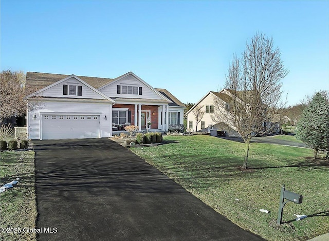 view of front of property with driveway, a porch, an attached garage, a front lawn, and brick siding