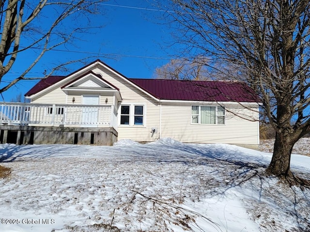 view of front of house with metal roof and a deck