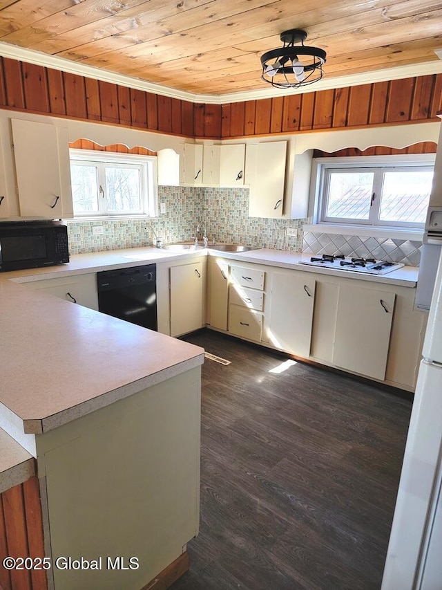 kitchen with tasteful backsplash, black appliances, wood ceiling, and light countertops