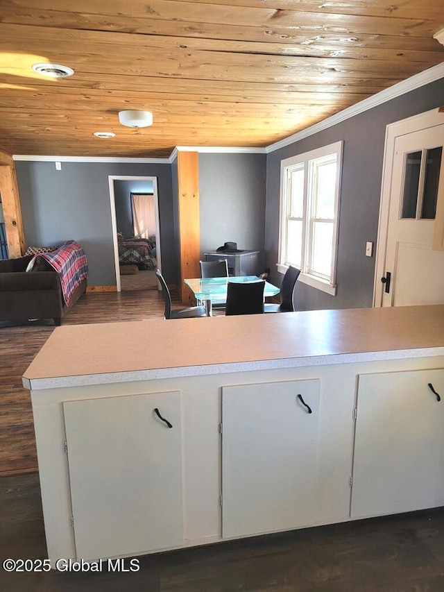 kitchen featuring open floor plan, wooden ceiling, visible vents, and crown molding