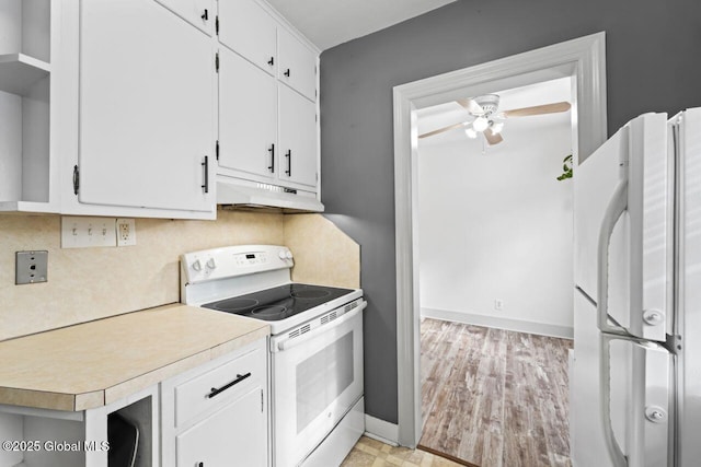 kitchen featuring white appliances, ceiling fan, light countertops, under cabinet range hood, and white cabinetry