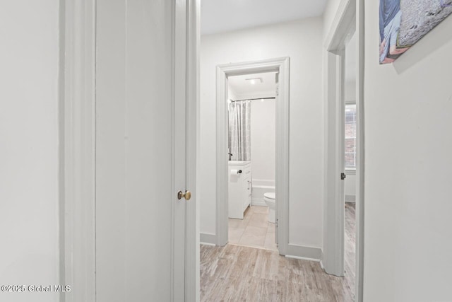 corridor with light wood-style floors