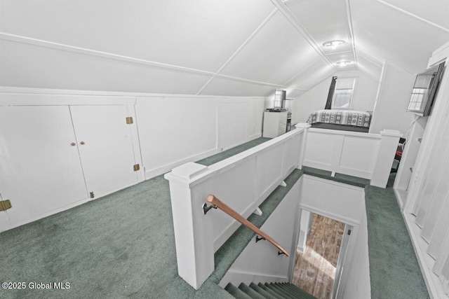 additional living space featuring carpet floors and lofted ceiling