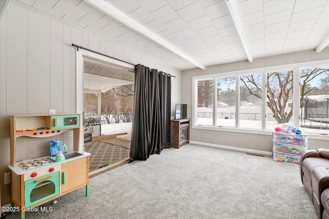 playroom with visible vents, carpet, and beam ceiling