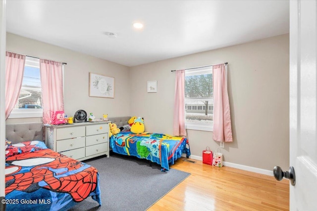 bedroom featuring baseboards and wood finished floors