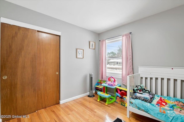 bedroom featuring wood finished floors and baseboards