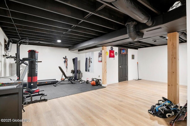 workout room featuring visible vents and wood finished floors