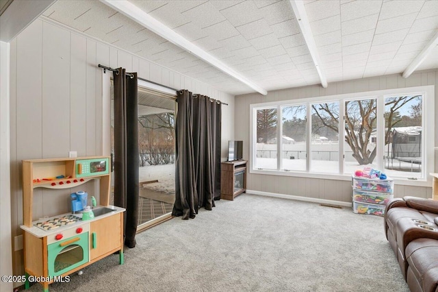 rec room featuring beam ceiling and light carpet