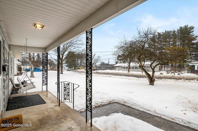 snowy yard with a porch