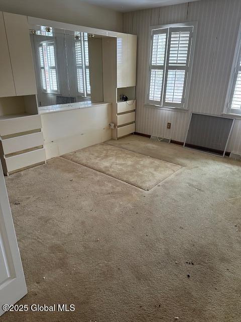 empty room featuring light colored carpet