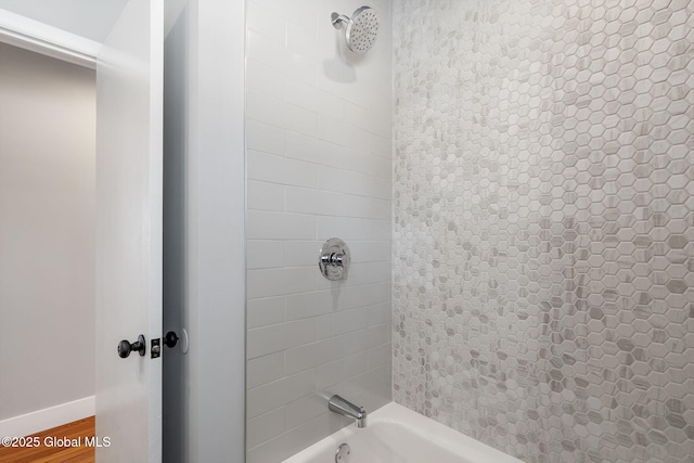 full bathroom featuring wood finished floors, shower / tub combination, and baseboards