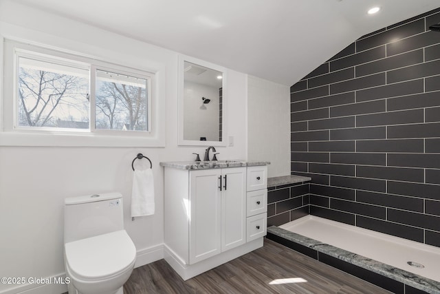 full bath featuring lofted ceiling, toilet, wood finished floors, vanity, and tiled shower