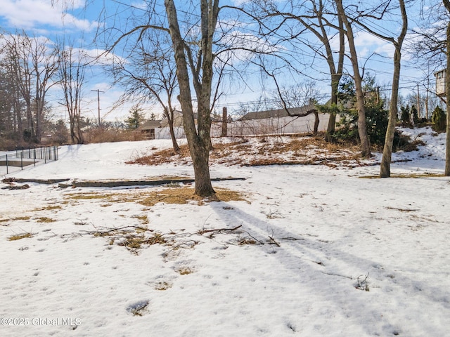 yard covered in snow with fence