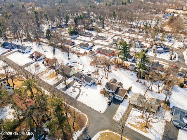 snowy aerial view with a residential view