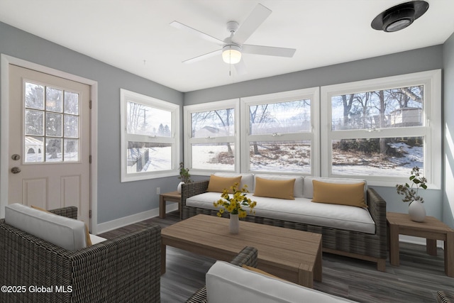 sunroom featuring a ceiling fan