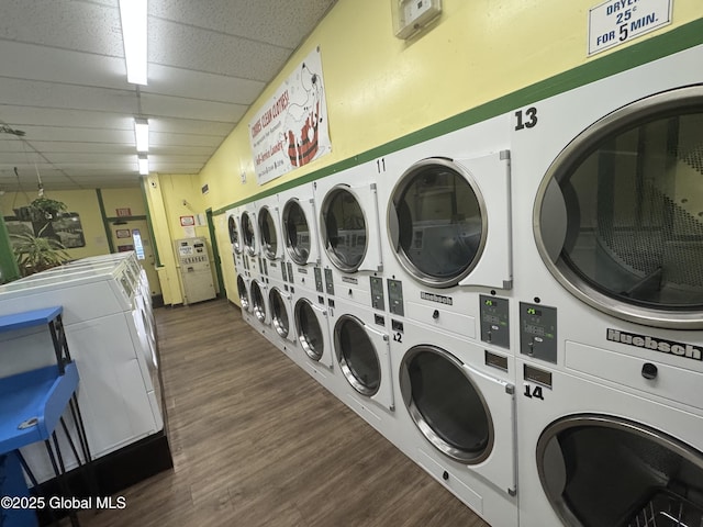 shared laundry area with dark wood-style floors, washing machine and dryer, and stacked washer / drying machine