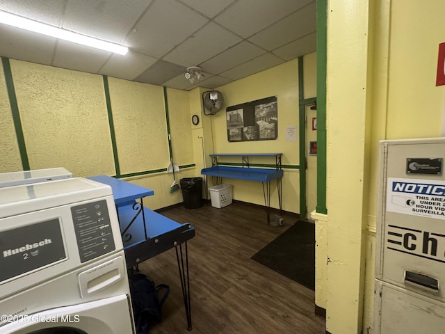 clothes washing area with washer and dryer and wood finished floors