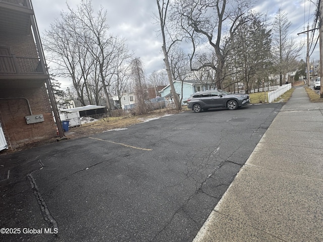 view of parking / parking lot featuring a residential view