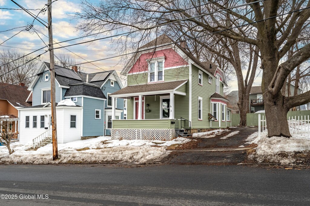 3 W Madison Ave, Johnstown, NY 12095 - view of front of home featuring covered porch, a shingled roof, a residential view, and entry steps