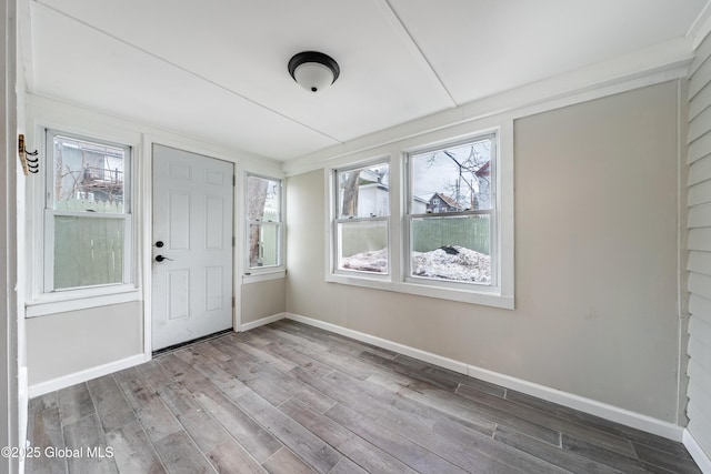 foyer featuring baseboards and wood finished floors