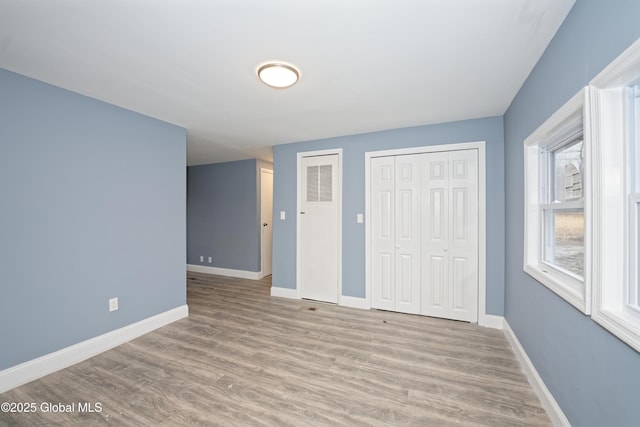 empty room featuring wood finished floors and baseboards