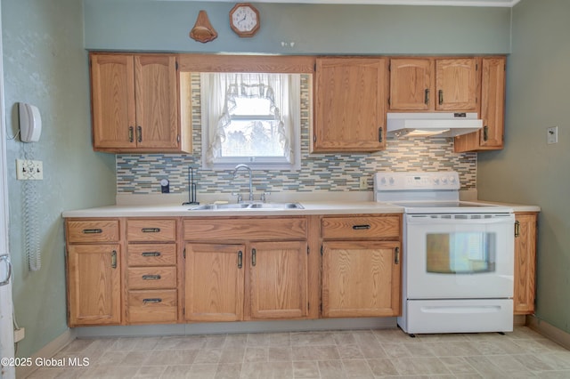 kitchen featuring under cabinet range hood, white electric range, a sink, light countertops, and decorative backsplash