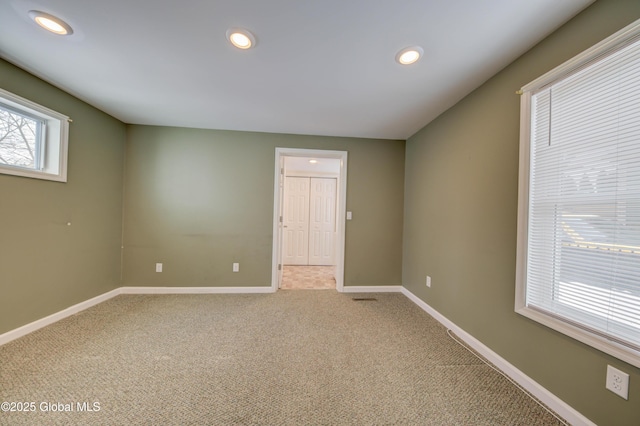 unfurnished room featuring light carpet, recessed lighting, and baseboards