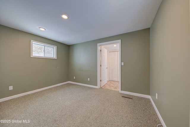 spare room with recessed lighting, baseboards, and carpet floors