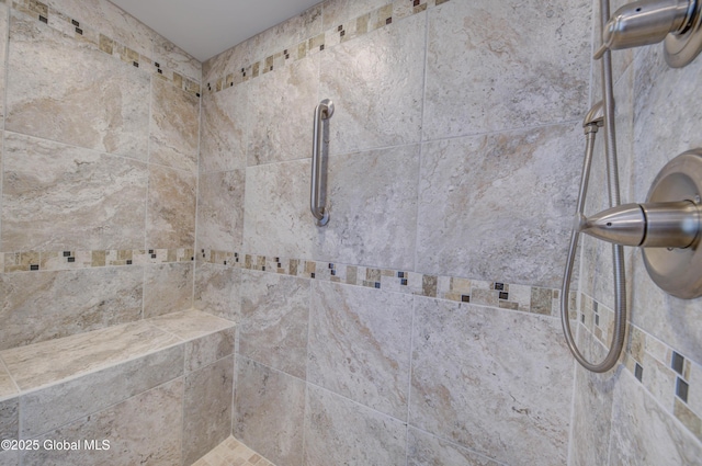 interior details with a tile shower