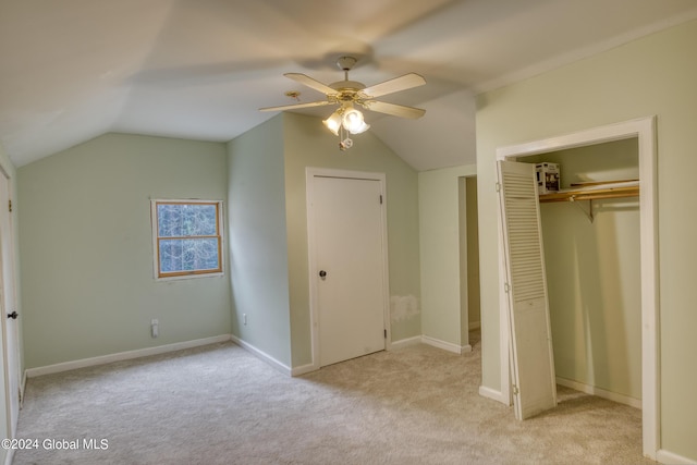 unfurnished bedroom featuring carpet floors, ceiling fan, baseboards, and vaulted ceiling