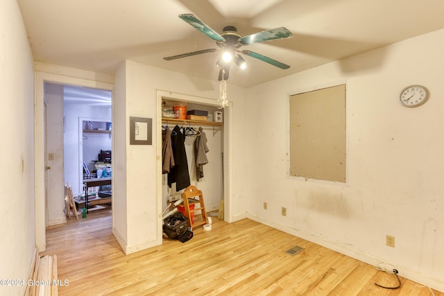 bedroom with baseboards, a closet, visible vents, and wood finished floors