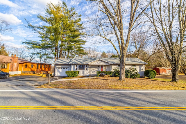 view of front of home featuring aphalt driveway and an attached garage