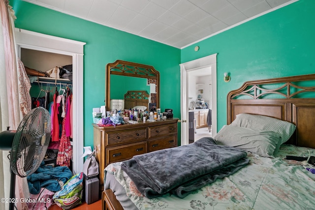 bedroom with ornamental molding and a closet